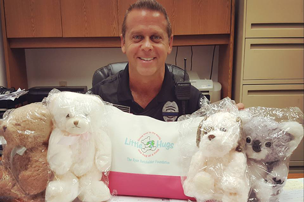 delray beach police office with little hugs donated