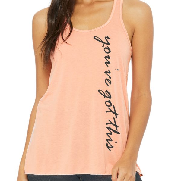 front of woman's peach tank top with "you've got this" printed running down the length of