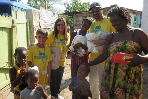 jamaican family with donated stuffed animals from little hugs